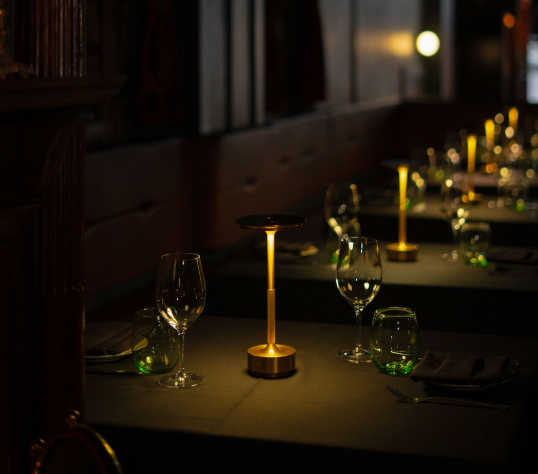 Candlelit tables set for dinner in the dining room
